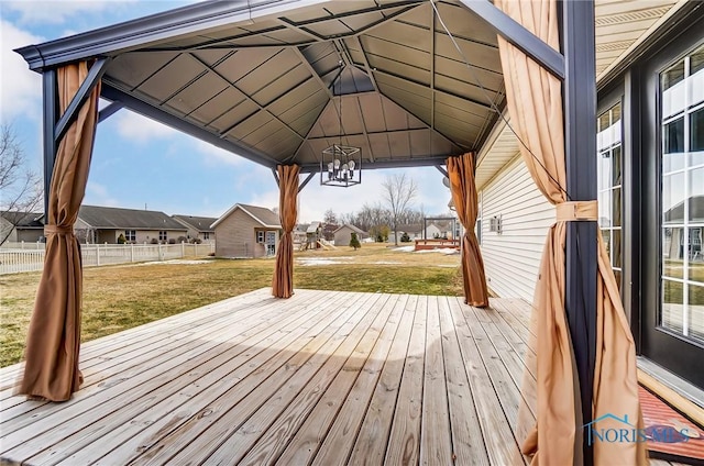 wooden deck with a yard, a residential view, fence, and a gazebo