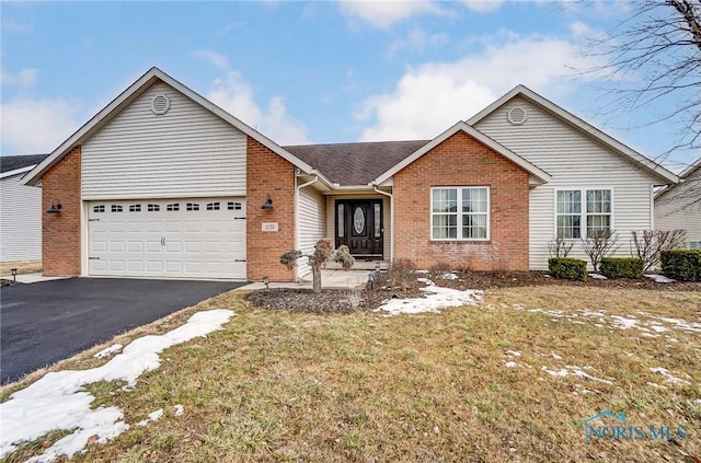 ranch-style home with driveway, brick siding, a front lawn, and an attached garage