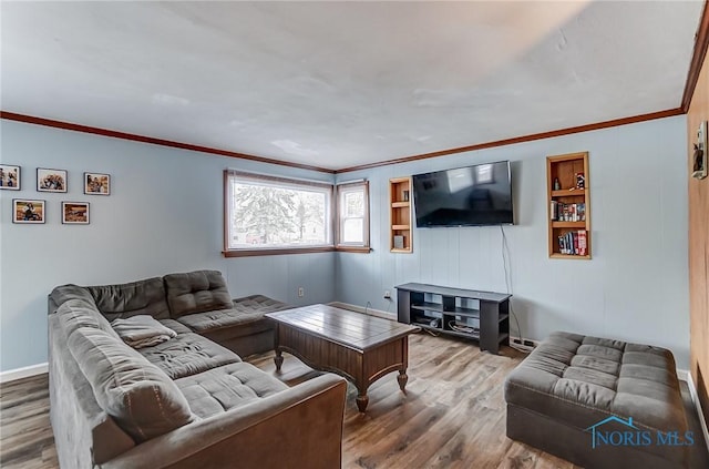 living room with ornamental molding, wood finished floors, and baseboards