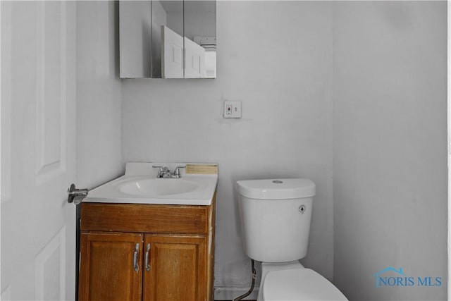 bathroom featuring toilet and vanity