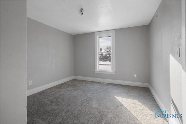 unfurnished room featuring carpet flooring and baseboards