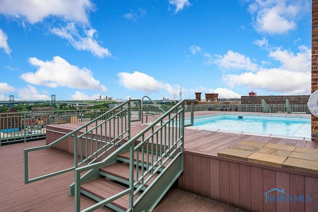 view of swimming pool featuring a fenced in pool and stairway