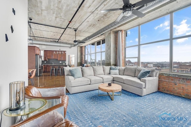 carpeted living area featuring a ceiling fan and a healthy amount of sunlight