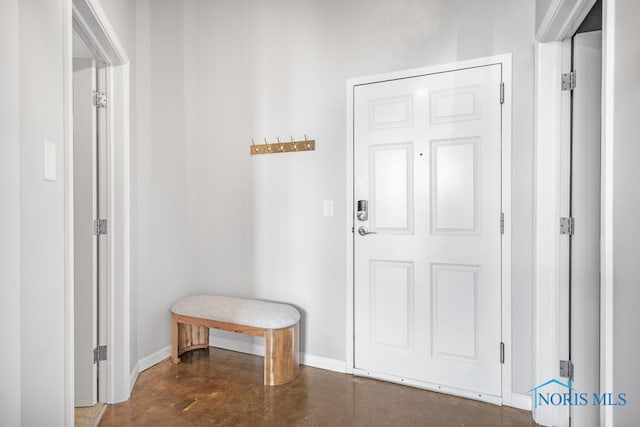 interior space with finished concrete floors and baseboards