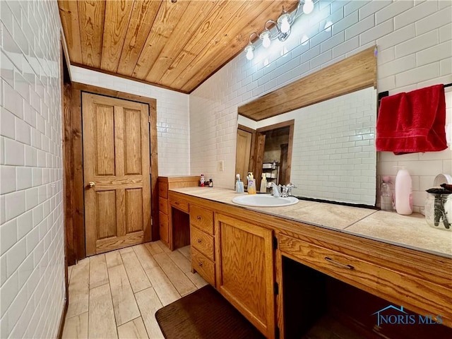 3190 Rd 204, Antwerp, OH 45813 - bathroom with tile walls, vanity, wood finished floors, and wooden ceiling