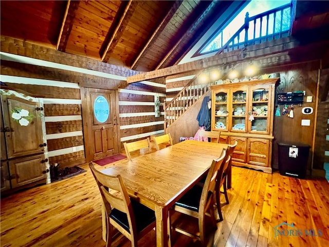 3190 Rd 204, Antwerp, OH 45813 - dining space featuring wood walls, light wood-type flooring, stairway, a wood ceiling with exposed beams, and high vaulted ceiling