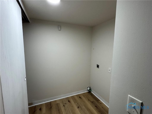 washroom featuring laundry area, baseboards, wood finished floors, hookup for an electric dryer, and washer hookup