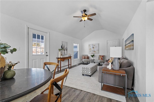 living area featuring ceiling fan, vaulted ceiling, and wood finished floors