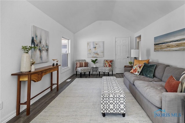 living area featuring dark wood-style floors, lofted ceiling, and baseboards