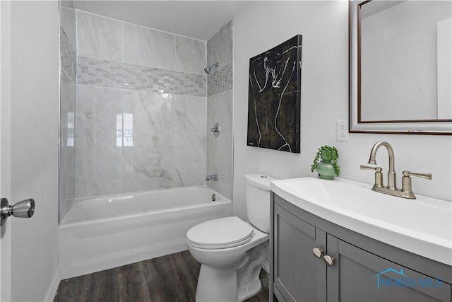 full bathroom with shower / bathtub combination, vanity, toilet, and wood finished floors