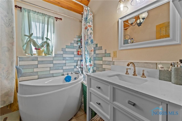 full bath featuring a freestanding bath, tile walls, and vanity