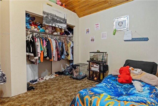 carpeted bedroom with a closet and wood ceiling