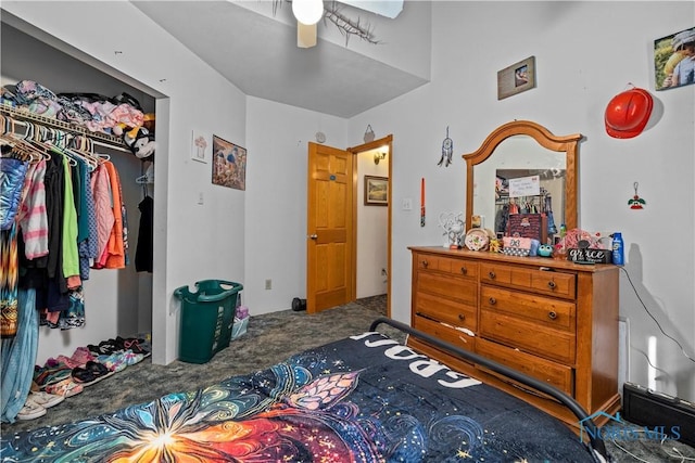 carpeted bedroom featuring ceiling fan and a closet