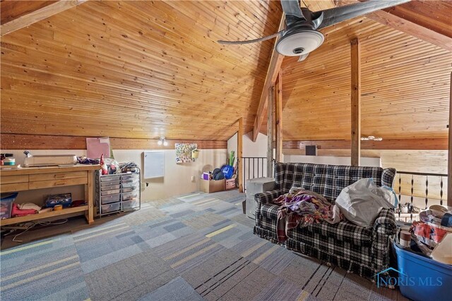 additional living space with a ceiling fan, lofted ceiling, wooden ceiling, carpet flooring, and wood walls