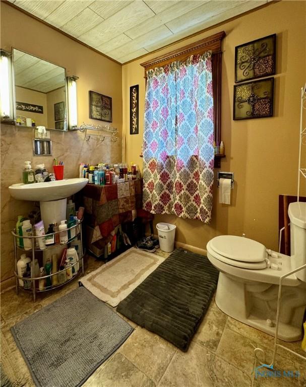 bathroom with wood ceiling, toilet, and crown molding