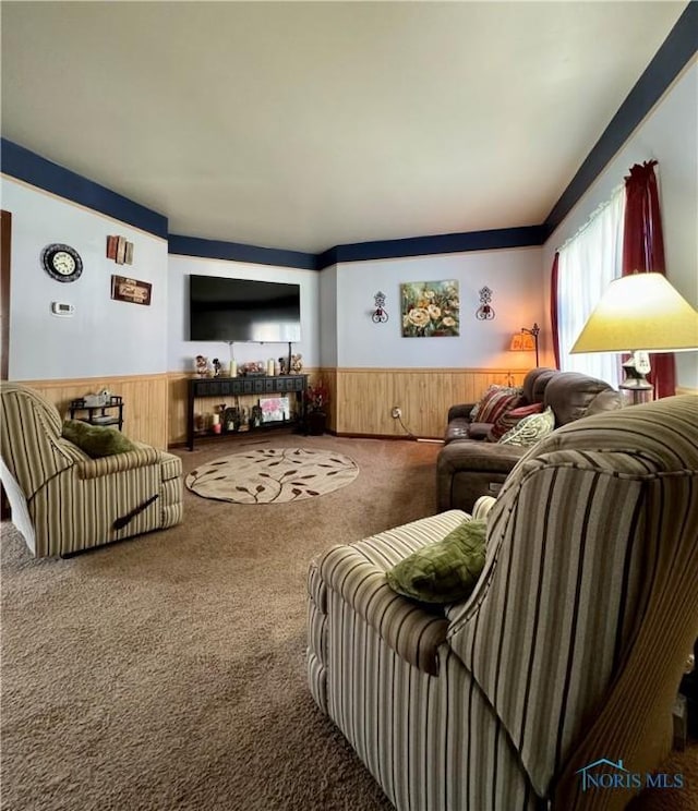 living area with carpet floors, wood walls, and wainscoting