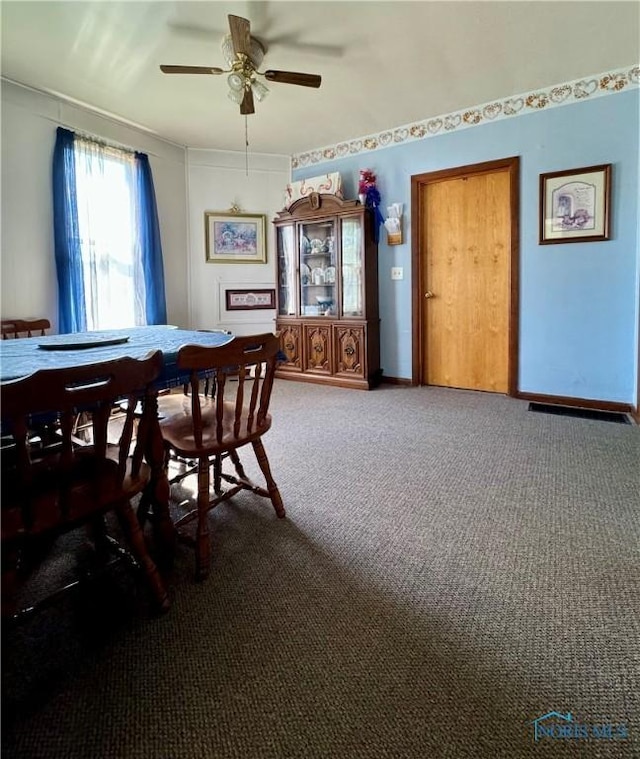 dining space featuring a ceiling fan, baseboards, and carpet flooring