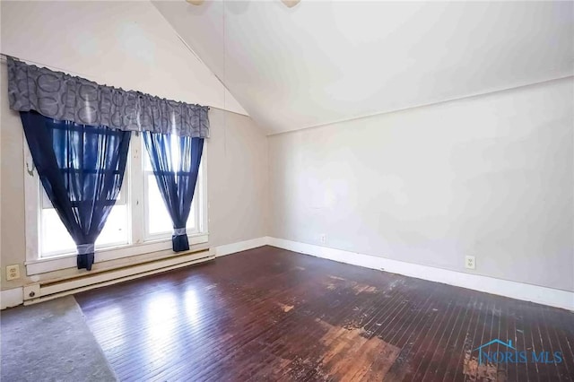 empty room with lofted ceiling, dark wood-type flooring, a baseboard radiator, and baseboards