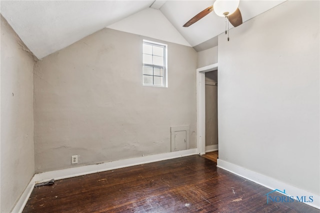 bonus room featuring vaulted ceiling, dark wood-style floors, a ceiling fan, and baseboards