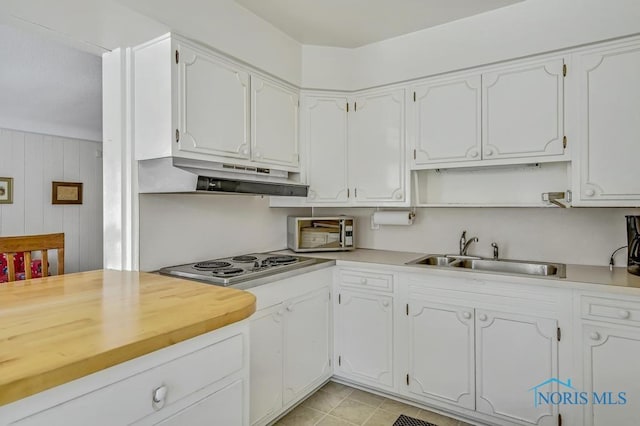 kitchen with appliances with stainless steel finishes, white cabinets, and a sink