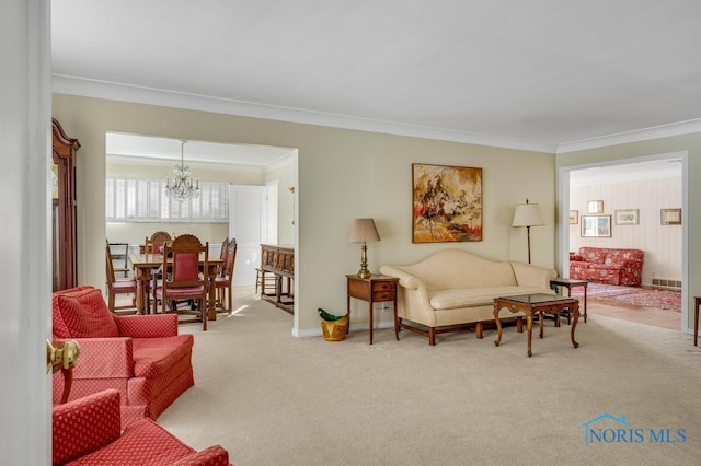 carpeted living room with crown molding, baseboards, and a notable chandelier