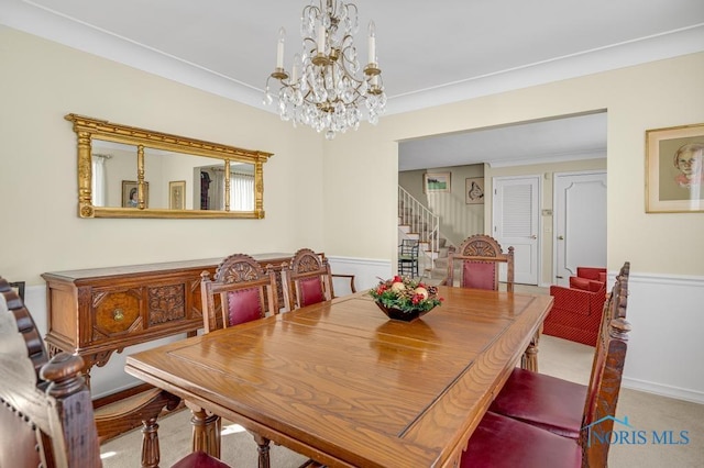 dining room with stairway, a notable chandelier, and light colored carpet