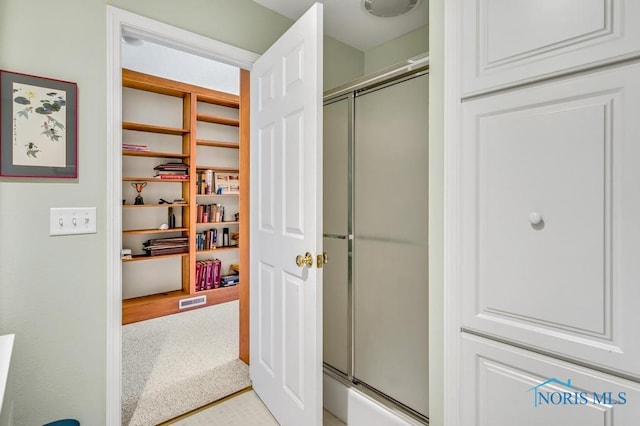 bathroom featuring a stall shower and visible vents