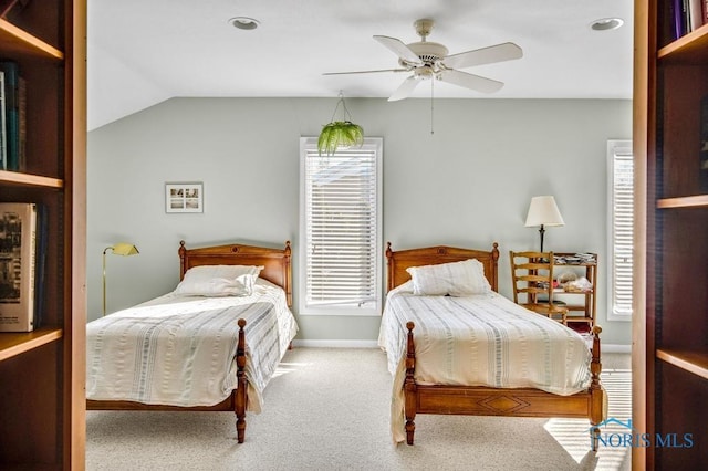 carpeted bedroom featuring vaulted ceiling, baseboards, and ceiling fan