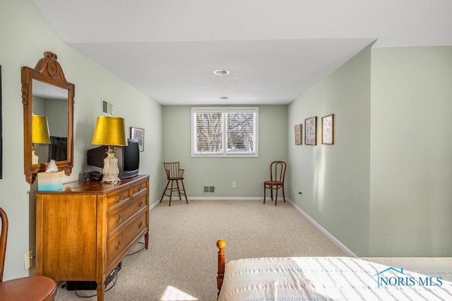 bedroom with baseboards, visible vents, and light colored carpet