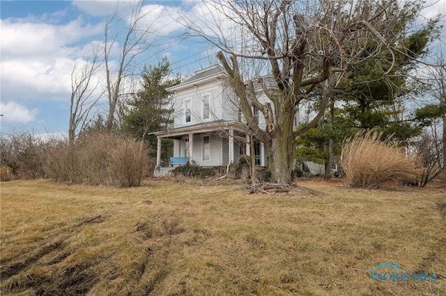 exterior space featuring a porch and a front lawn