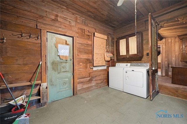 washroom featuring light floors, washing machine and dryer, wood ceiling, wooden walls, and laundry area