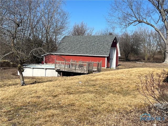 exterior space with an outbuilding and an outdoor pool