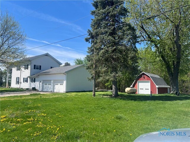 17020 State Route 2, Wauseon, OH 43567 - view of yard featuring a garage, a shed, an outbuilding, and driveway