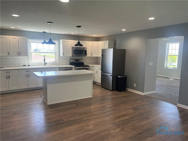 17020 State Route 2, Wauseon, OH 43567 - kitchen with backsplash, appliances with stainless steel finishes, a center island, a sink, and baseboards