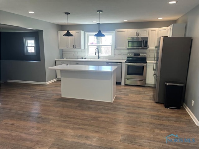 17020 State Route 2, Wauseon, OH 43567 - kitchen with backsplash, a sink, light countertops, stainless steel appliances, and white cabinetry