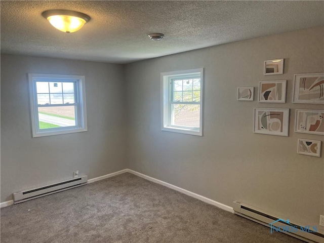 17020 State Route 2, Wauseon, OH 43567 - empty room with baseboards, a baseboard radiator, carpet flooring, and a textured ceiling