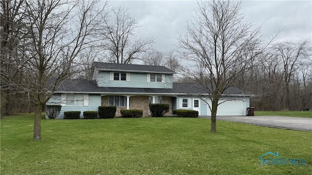 713 E Perry St, Paulding, OH 45879 - traditional-style house featuring a front lawn, a garage, and aphalt driveway