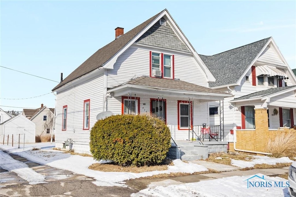 view of front of home with a shingled roof, cooling unit, covered porch, and a chimney