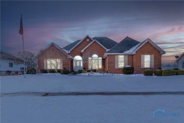 ranch-style home featuring brick siding