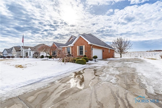 view of front of property featuring brick siding and an attached garage