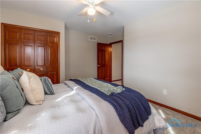 carpeted bedroom with baseboards, visible vents, ceiling fan, and a closet