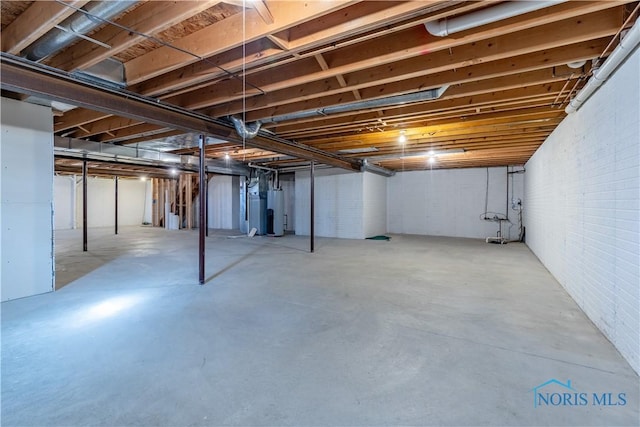 unfinished basement featuring water heater