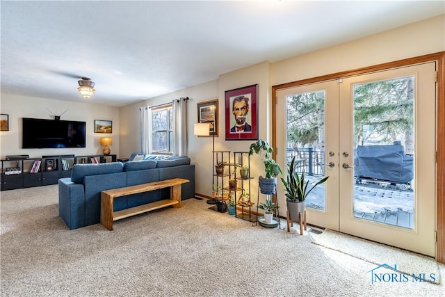 living room with french doors and carpet flooring