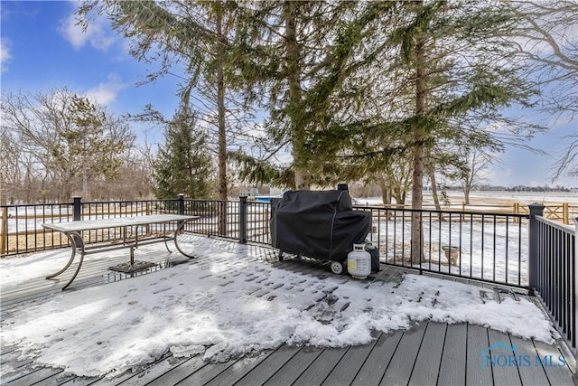 snow covered deck featuring a grill