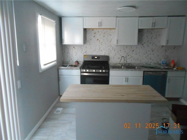 kitchen with white cabinets, stainless steel range with gas stovetop, dishwasher, and a sink