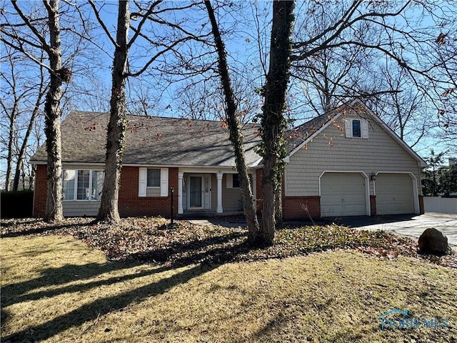 view of front of house with brick siding, driveway, and a front lawn