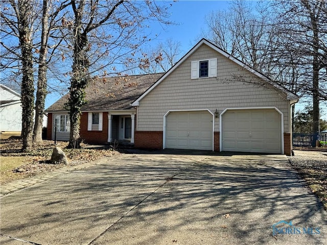 view of front of home with driveway, an attached garage, and brick siding