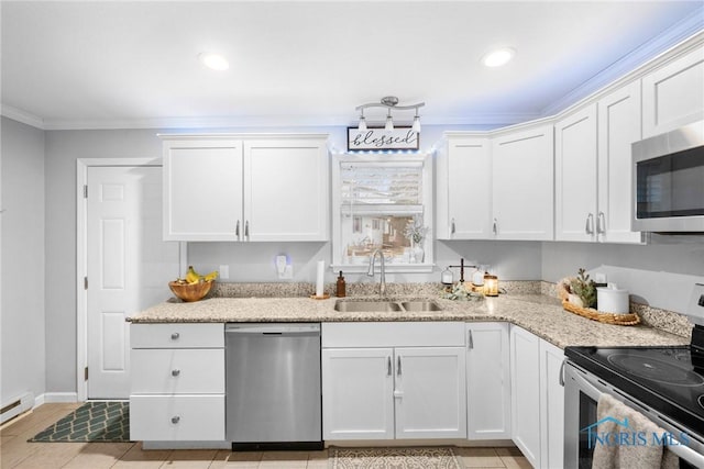 kitchen with white cabinetry, crown molding, appliances with stainless steel finishes, and a sink