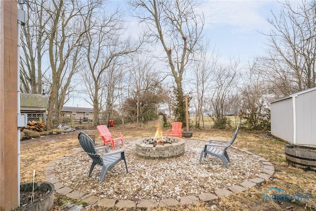 view of yard with an outdoor fire pit