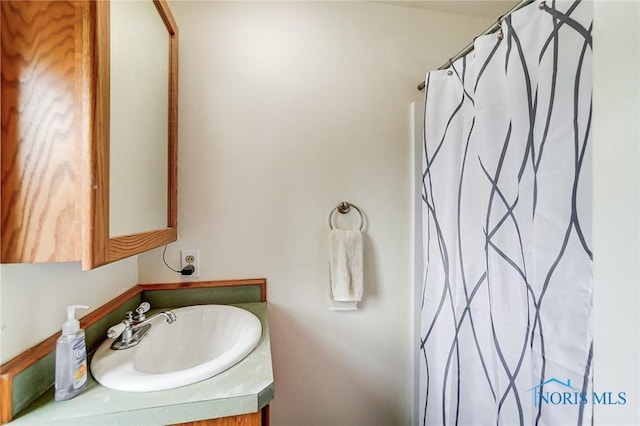 bathroom featuring vanity and a shower with shower curtain